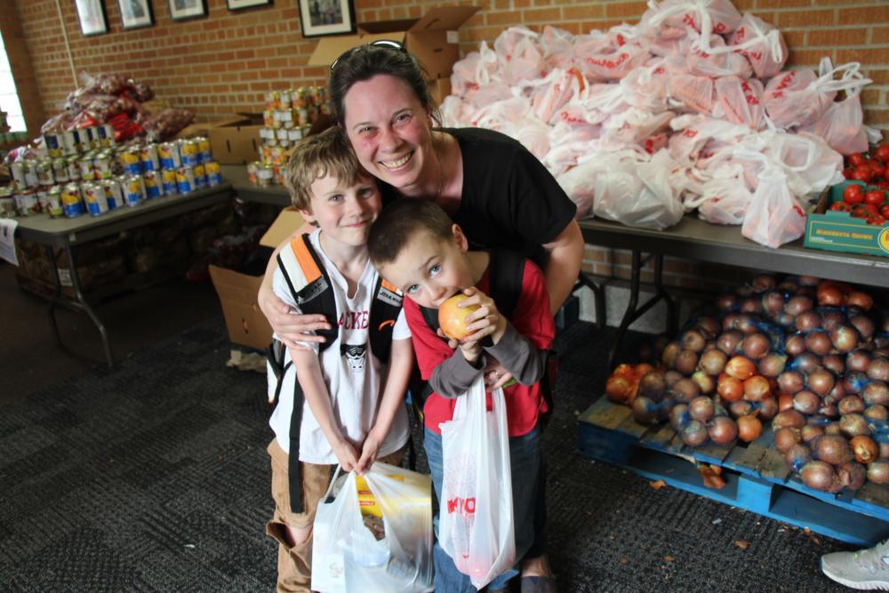 Mother with her two children at a food shelf