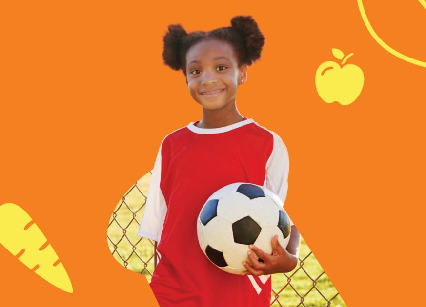 A little girl holding a soccer ball in front of an orange back-drop A little girl holding a soccer ball in front of an orange back-drop