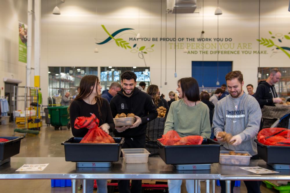 Volunteers pack potatoes during a volunteer shift