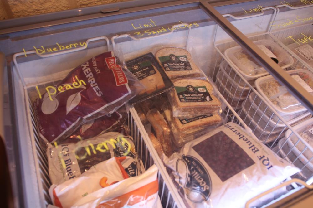 Bags of frozen fruits and vegetables in a freezer