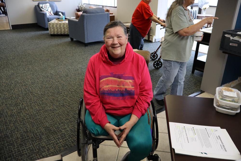 Woman in a red sweatshirt in a wheelchair