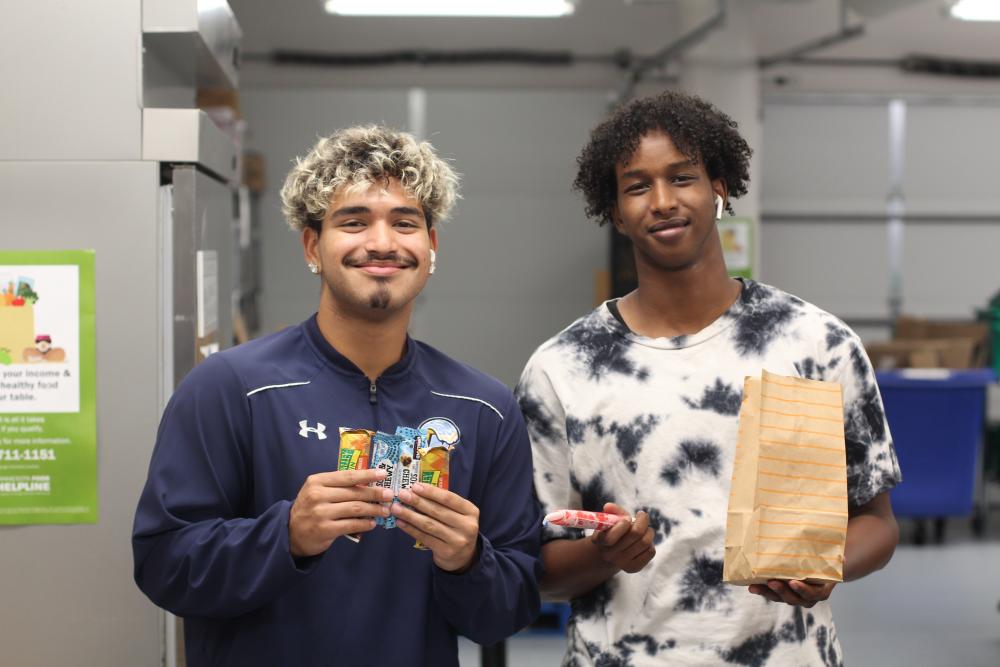 Two people standing at Food Shelf