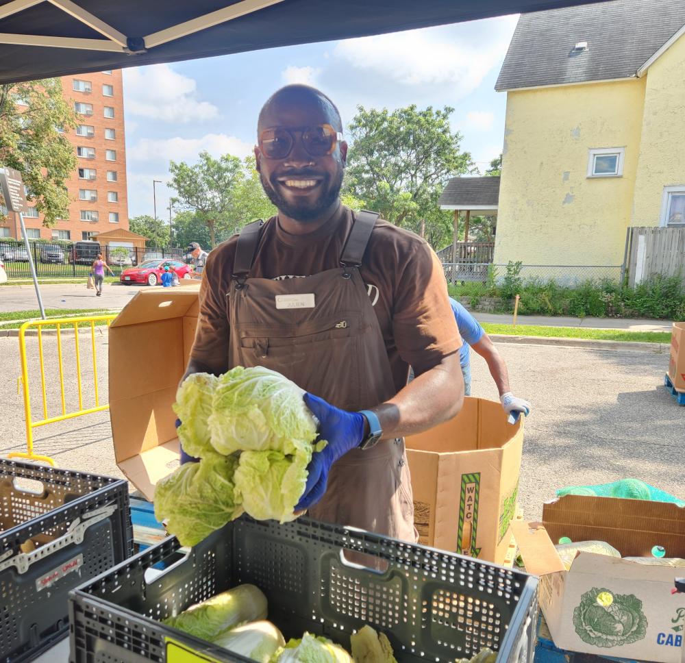A volunteer holding cabbage