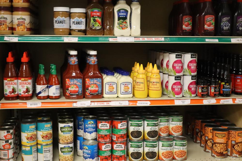 A shelf of condiments and canned goods