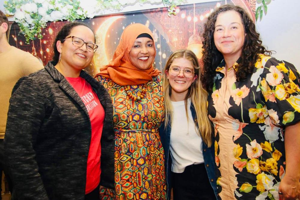Kitchen Coalition staff and Amina gather for a group photo