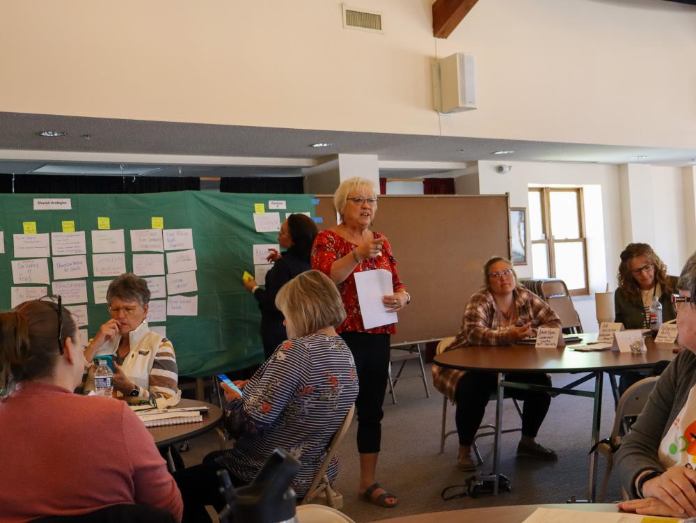A woman addresses a crowd at a meeting