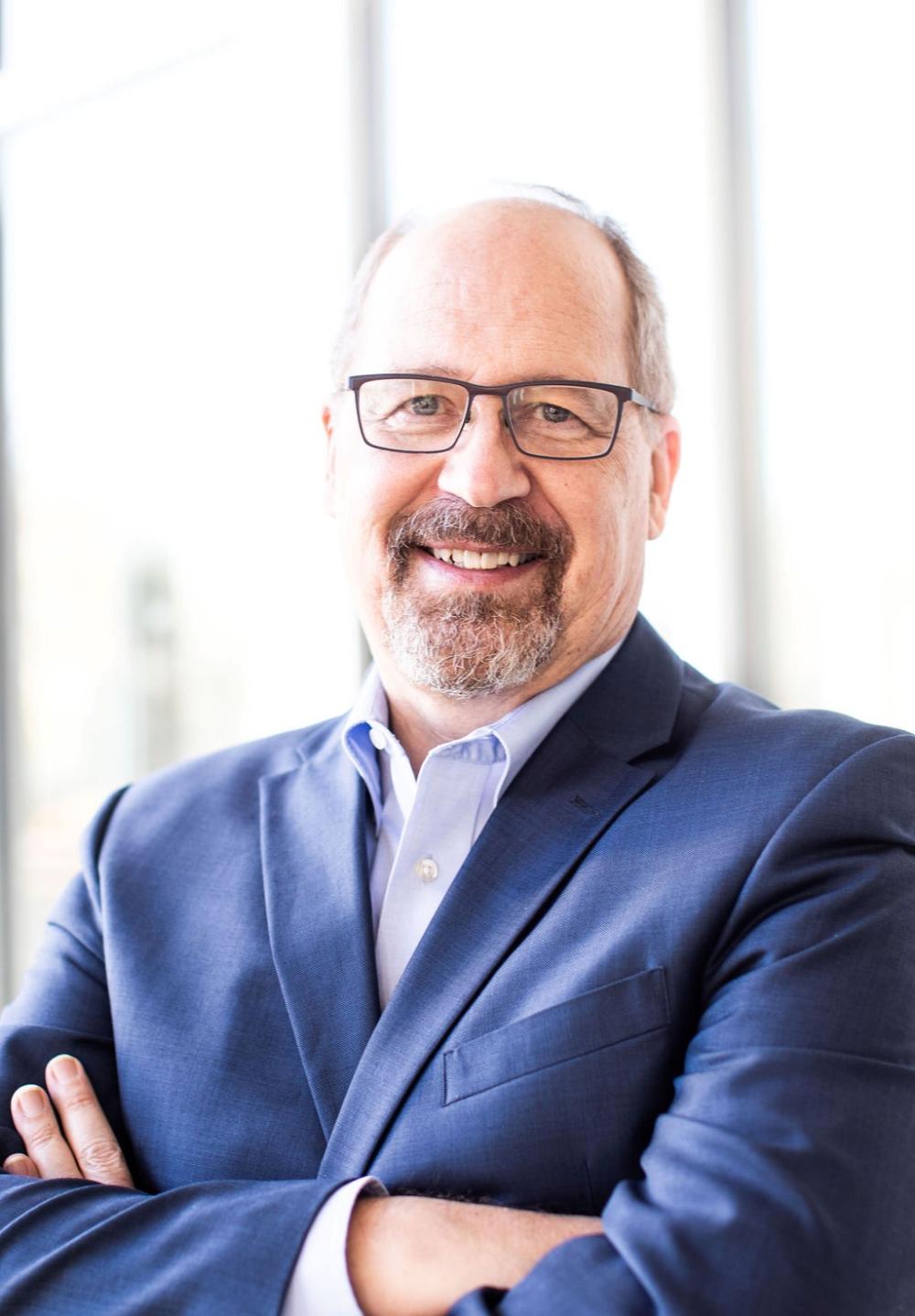 A portrait of a man in a blue suit