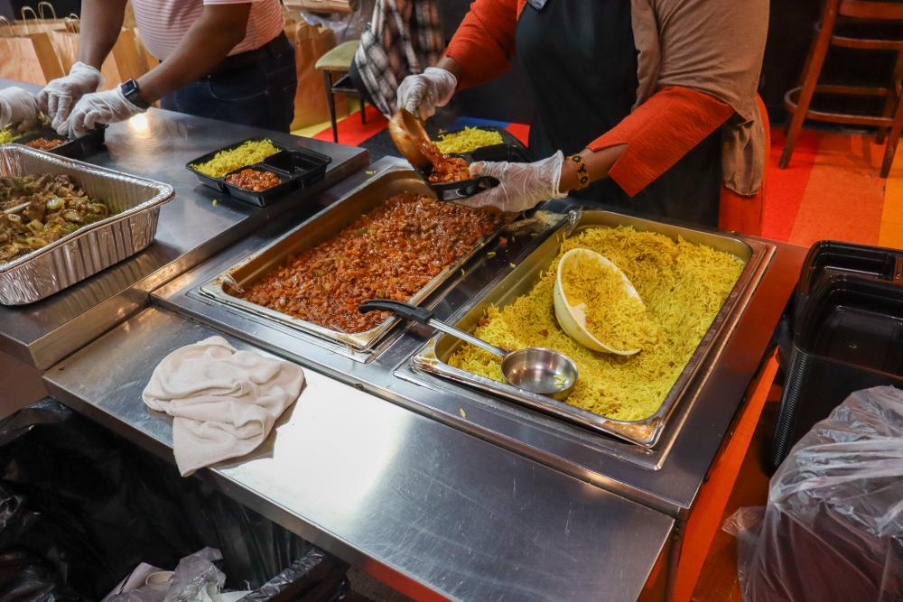A worker plates rice and beans