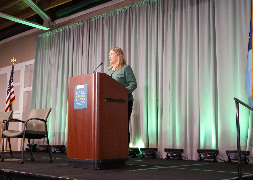 Sarah Moberg speaking at a podium