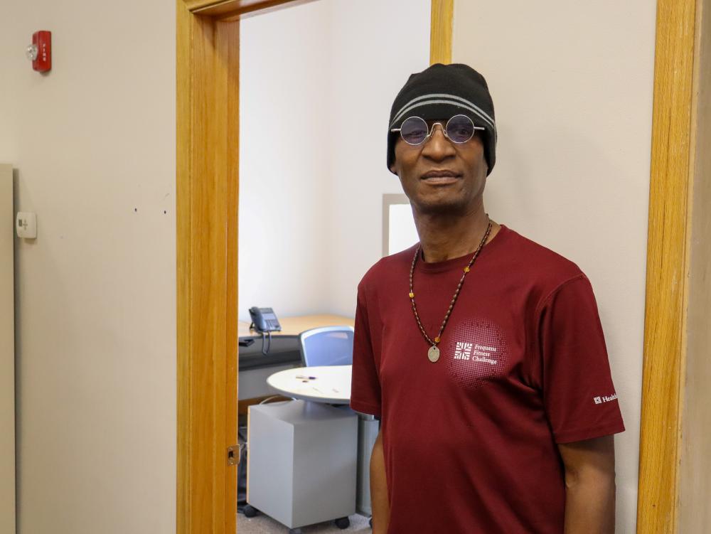 A portrait of a man in a red shirt
