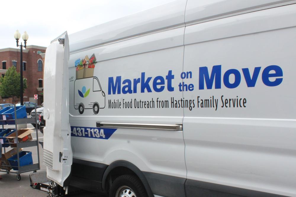 A white van with "Market on the Move" on the side