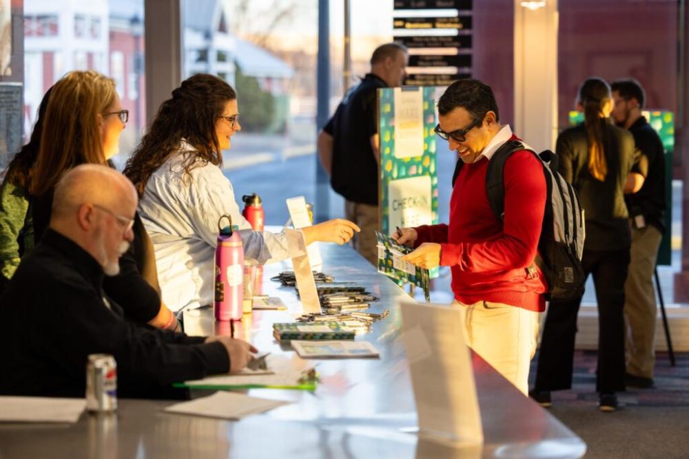 Attendee registering at the summit