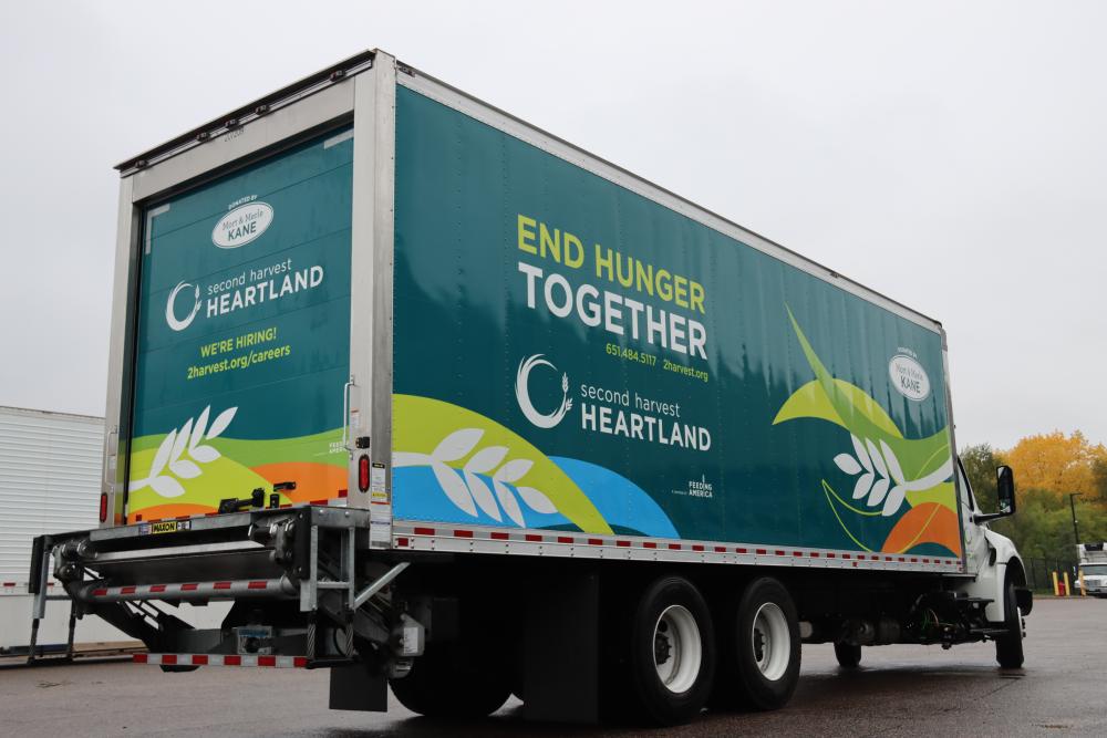 An SHH truck from a dramatic angle, prominently displaying the message “End Hunger Together” because it suits the topic of hunger relief funding for more food delivery