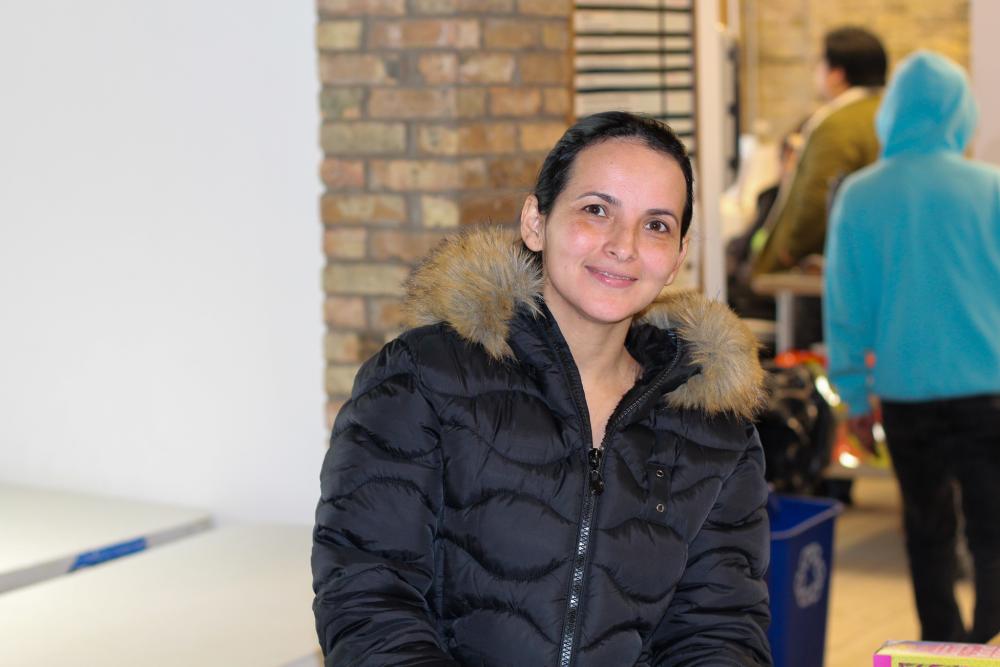 A woman in a coat at a food shelf