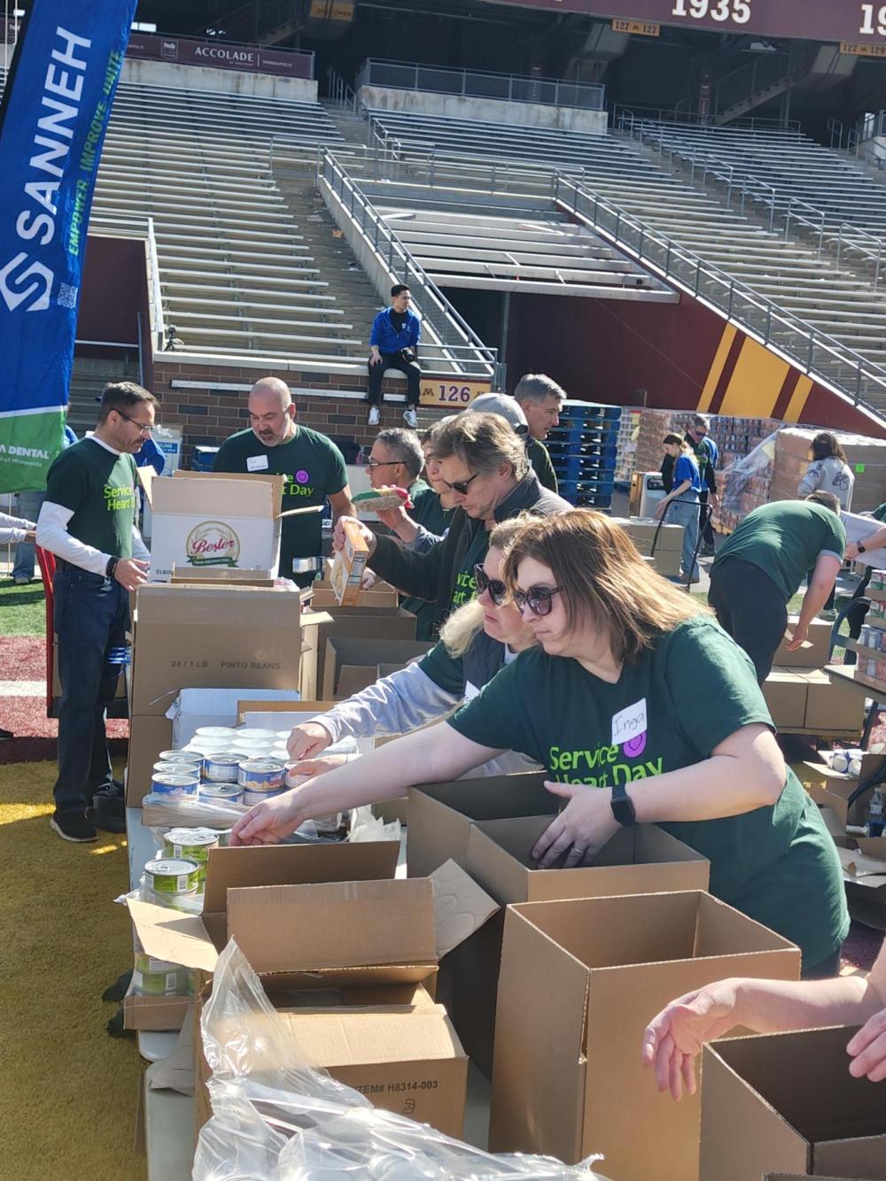 Volunteers packing food boxes in Huntington Bank Stadium