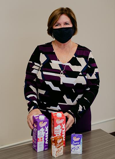 Portrait of Carolyn Erchul with milk at Prairie Farms