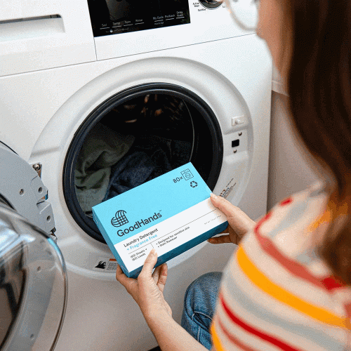 woman loading washer with laundry detergent sheets