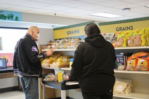Kirk (left) shopping at the Department of Indian Work food shelf