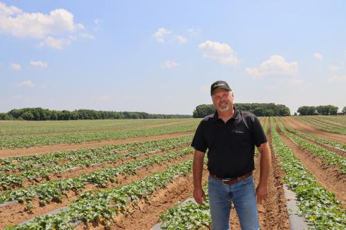 Farmer John Svihel standing by one of his fields