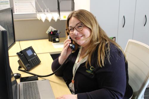 Desiree on the phone connecting with a community member