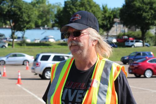 A volunteer directs traffic at Keystone’s Drive-Through Farmer’s Market