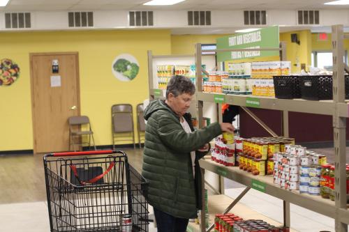 A shopper browses the shelves at a Food Bank