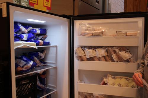 An open freezer filled with bags of vegetables