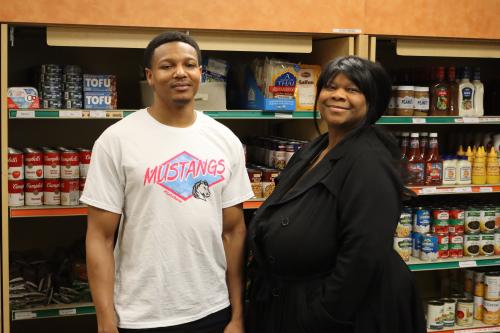 Two students at a food shelf