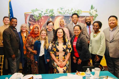 A group poses for a photo at a dinner