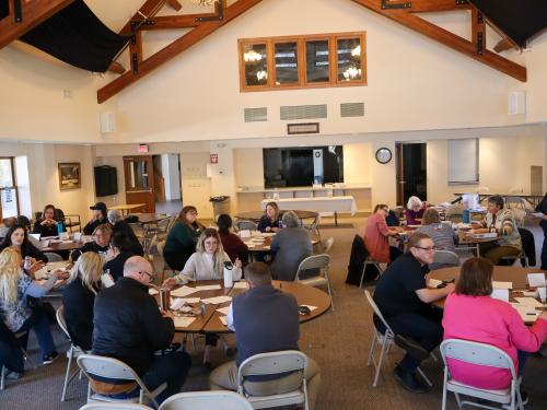 People at tables collaborate with each other