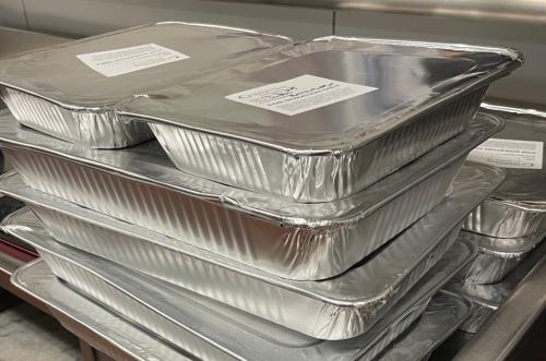 Foil-covered food pans Four levels of foil-covered food pans stacked on top of each other