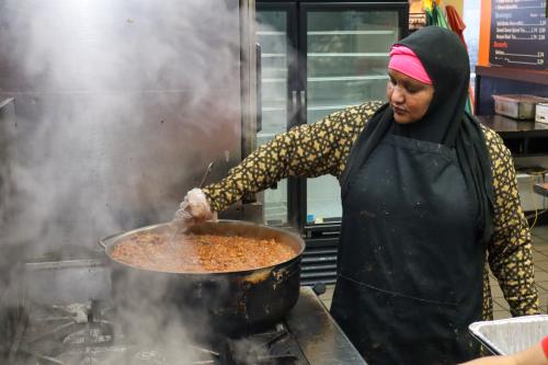 A chef stirs a pot of red beans