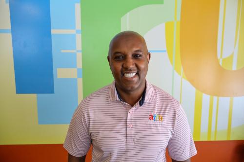 Kahin poses for a photo in his restaurant