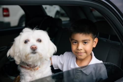 Child with their dog sitting down