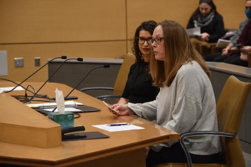 Mesa seated at a table, speaking into a mic