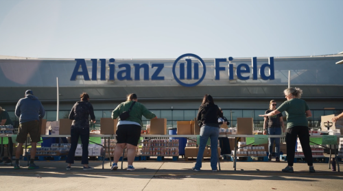 Volunteer food packing line outside Allianz Field