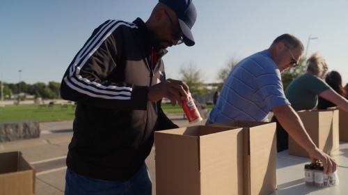 Volunteers packing food boxes with spices