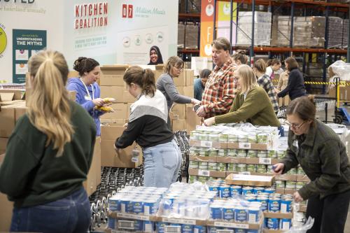 Volunteers on the emergency box assembly line in the Second Harvest Heartland warehouse
