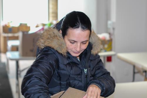 A shopper goes through an emergency food box at a food shelf