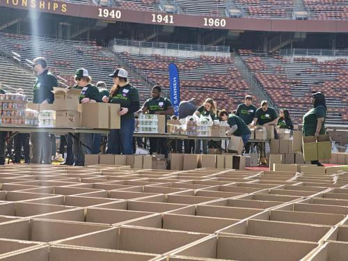 Volunteer pack boxes in a football stadium