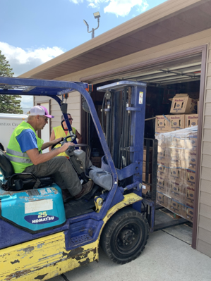 Man driving forklift outside